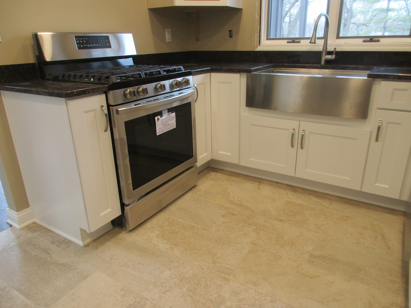 507 San Carlos Road Minooka, IL 60447 - Photo 7 of 48 a kitchen with granite countertop a stove and a sink