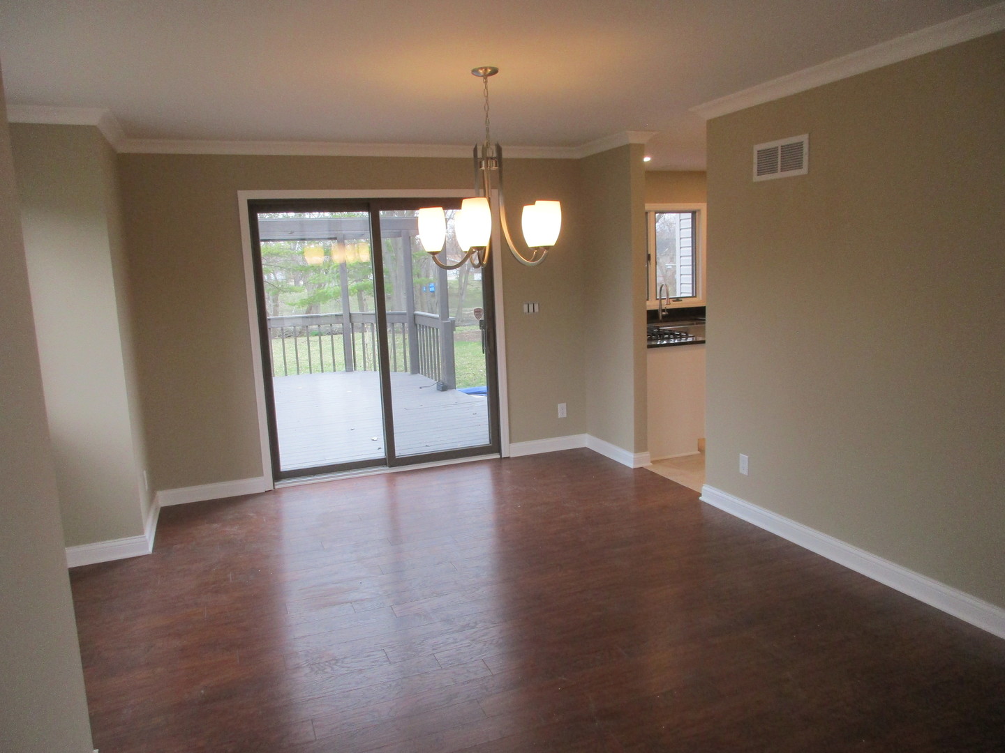 507 San Carlos Road Minooka, IL 60447 - Photo 8 of 48 a view of an empty room with window and wooden floor