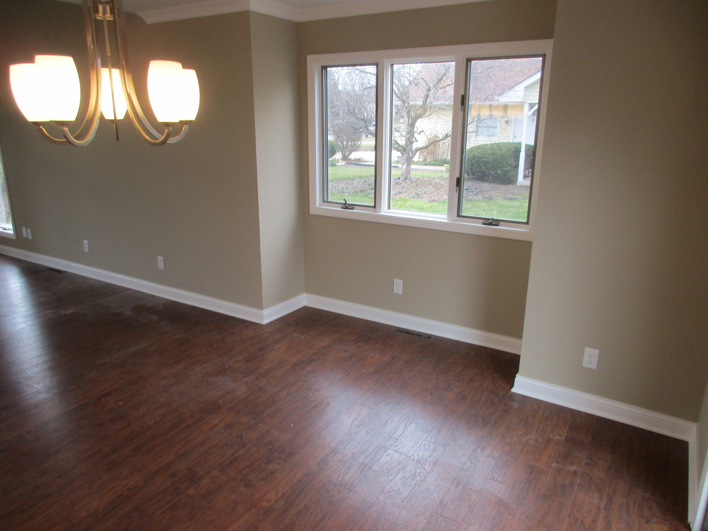 507 San Carlos Road Minooka, IL 60447 - Photo 9 of 48 an empty room with wooden floor and windows