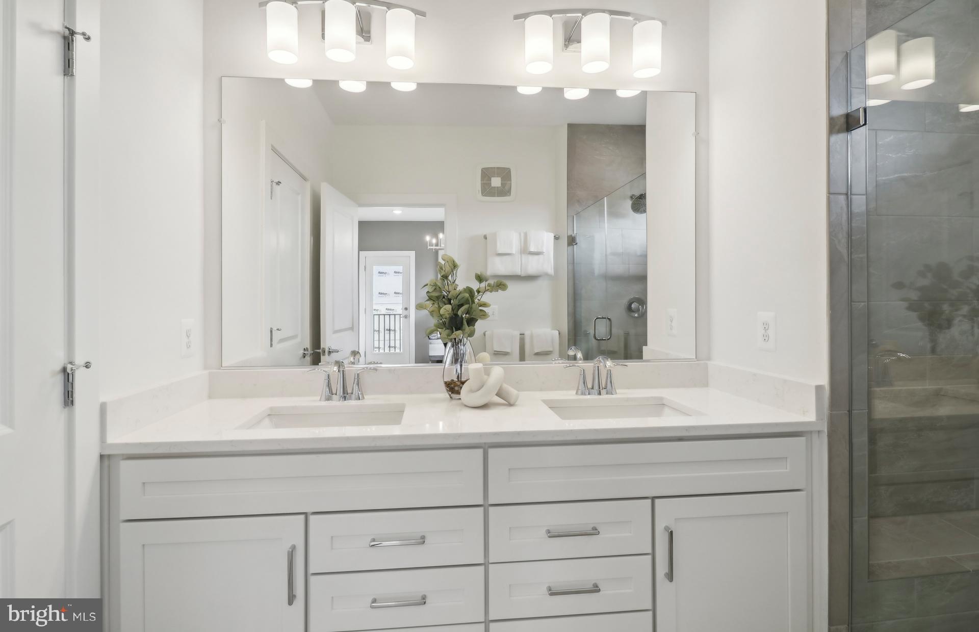 16104 Frederick Road Rockville, MD 20850 - Photo 10 of 34 a bathroom with double sink and a mirror