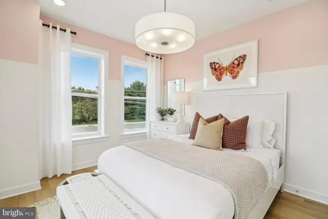 a living room with furniture a window and a chandelier