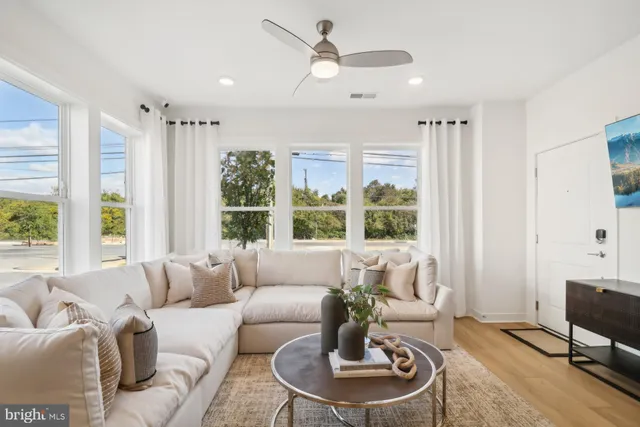 a living room with furniture and a large window