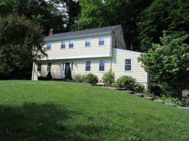 41 Fulling Mill Lane Ridgefield, CT 06877 - Photo 1 of 1 a front view of a house with a yard and trees