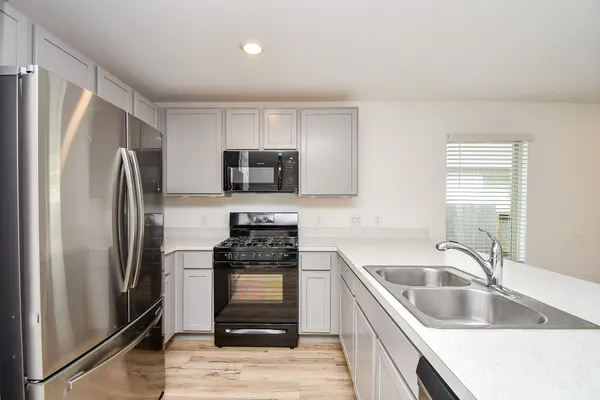 a kitchen with a refrigerator sink and microwave