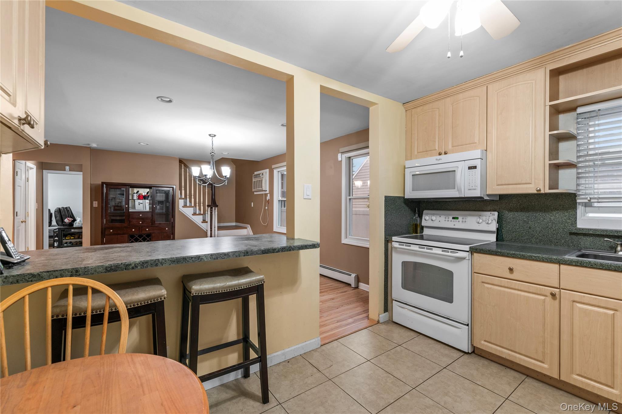 3 Cheshire Road Bethpage, NY 11714 - Photo 9 of 26 a kitchen with stainless steel appliances granite countertop a stove a sink and a refrigerator