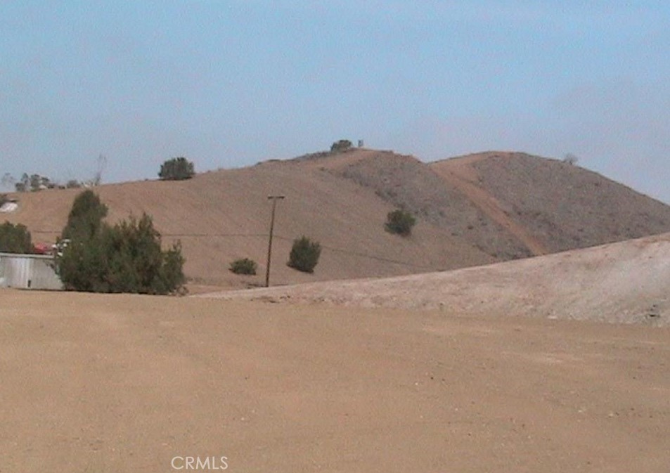 15255 Gavilan Springs Road Perris, CA 92570 - Photo 13 of 15 a view of a dry yard with mountains in the background