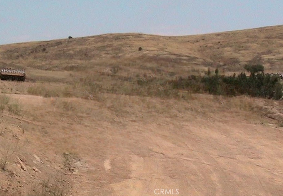 15255 Gavilan Springs Road Perris, CA 92570 - Photo 5 of 15 a view of a dry yard with mountains in the background