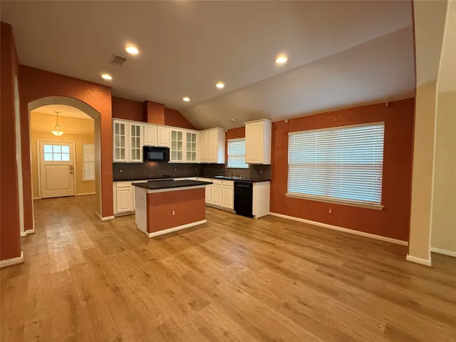 a large kitchen with stainless steel appliances granite countertop a stove and a sink