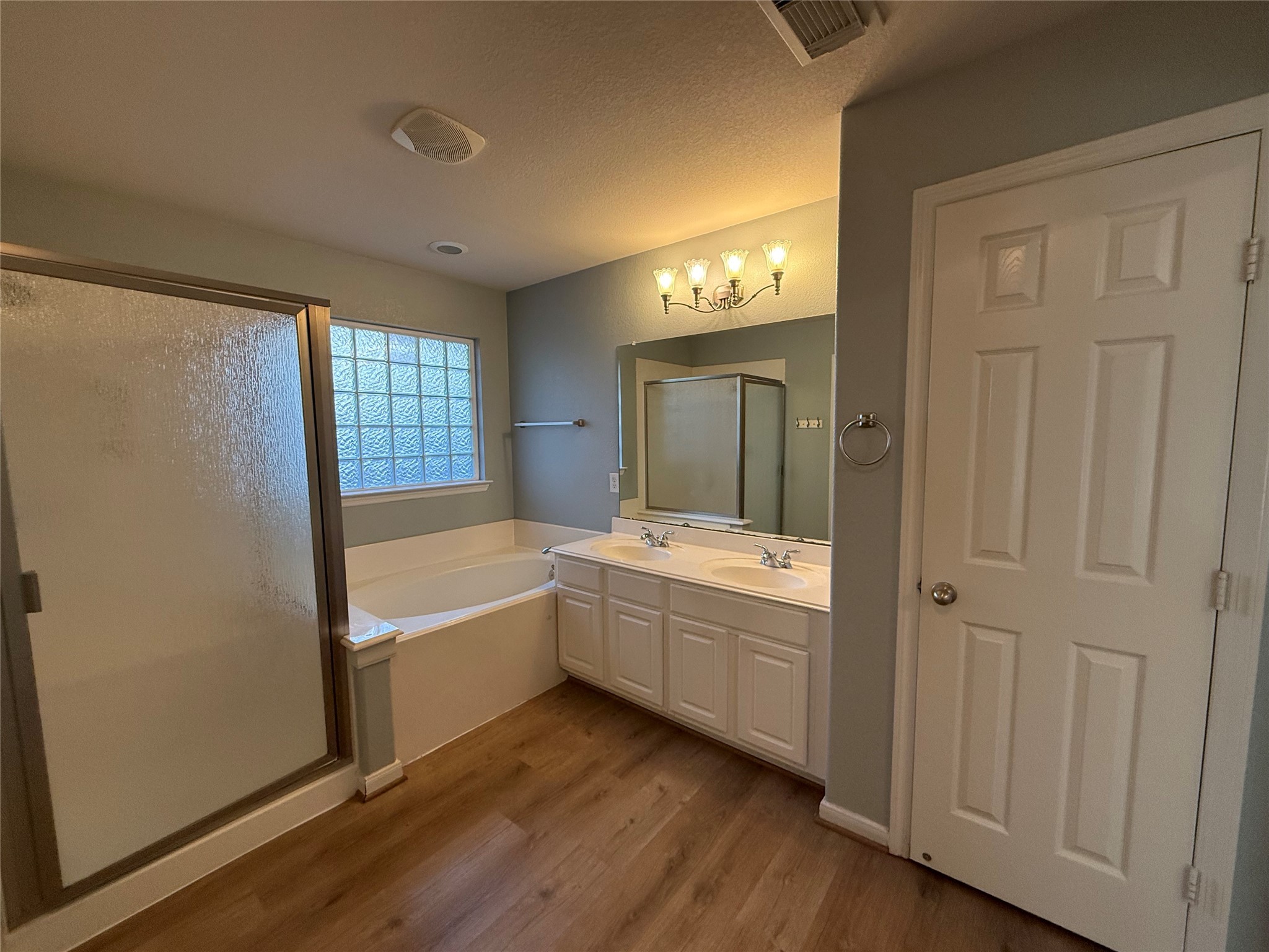 19407 Rosebud Ridge Way Spring, TX 77379 - Photo 17 of 18 a large bathroom with a tub sink shower and mirror