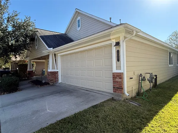 a view of a house with a small yard and a car parked beside it