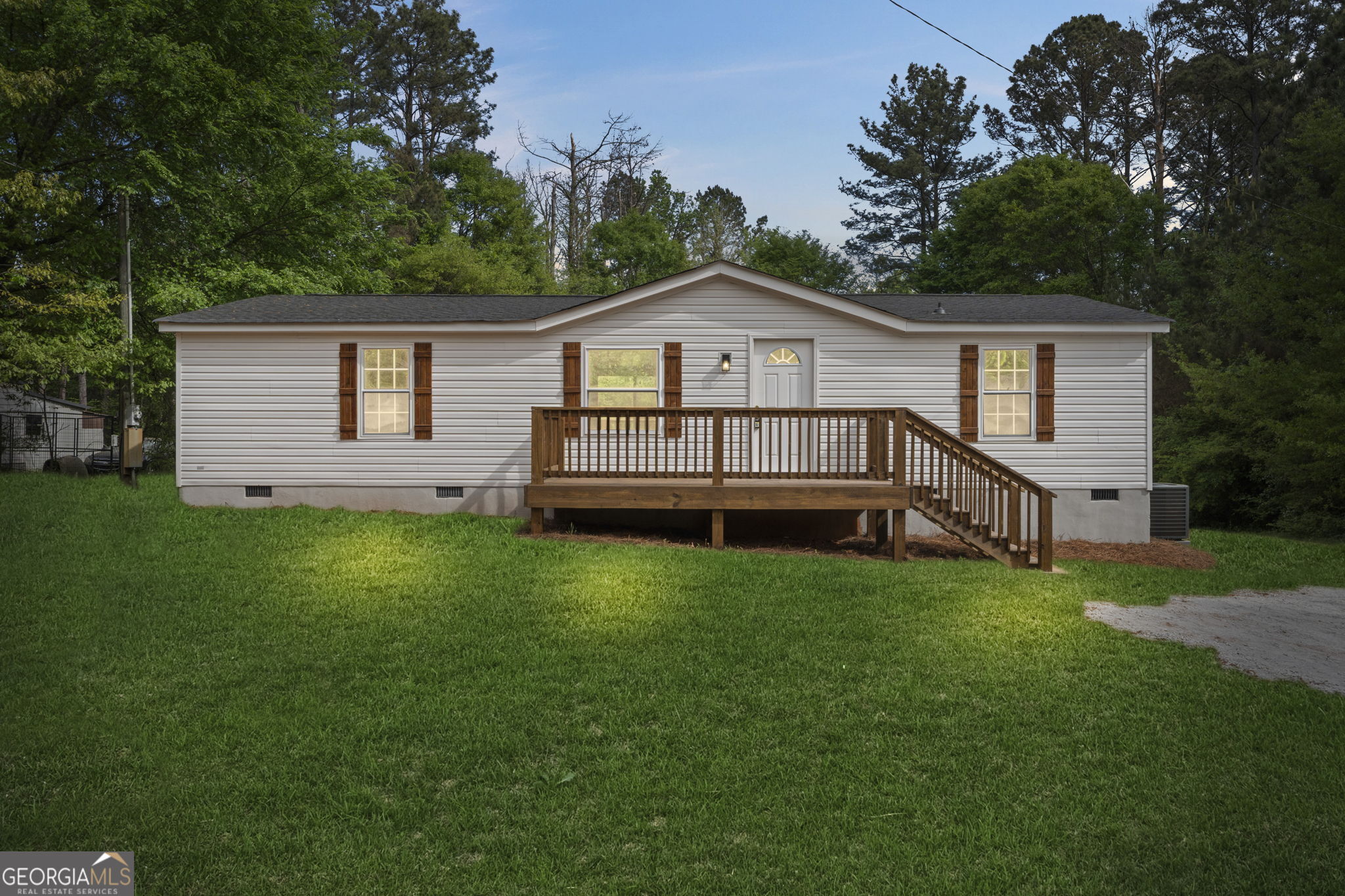 a view of a house with a yard and fence