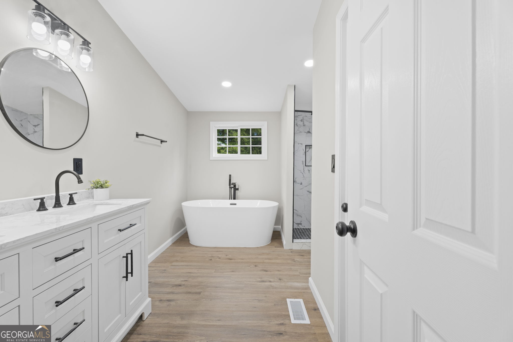 110 Kathy Lane Temple, GA 30179 - Photo 14 of 24 a spacious bathroom with a double vanity sink a mirror and a bathtub