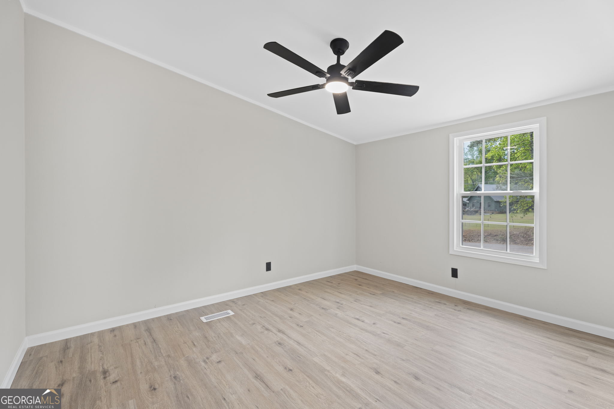 110 Kathy Lane Temple, GA 30179 - Photo 16 of 24 an empty room with wooden floor and windows