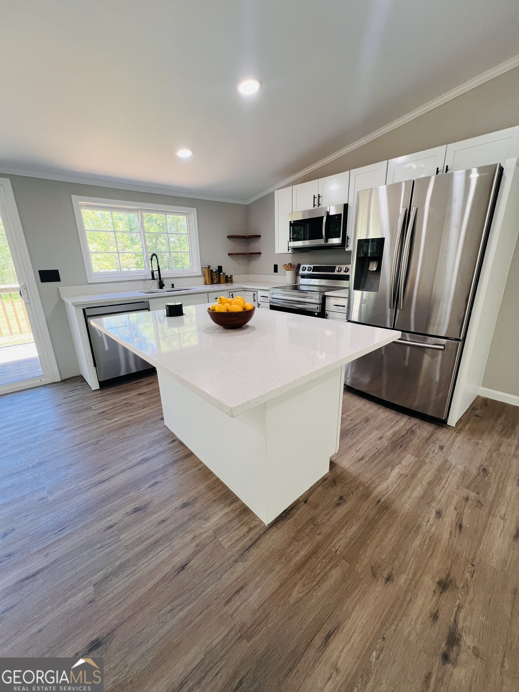 110 Kathy Lane Temple, GA 30179 - Photo 2 of 24 a kitchen view with wooden floor stainless steel appliances and windows