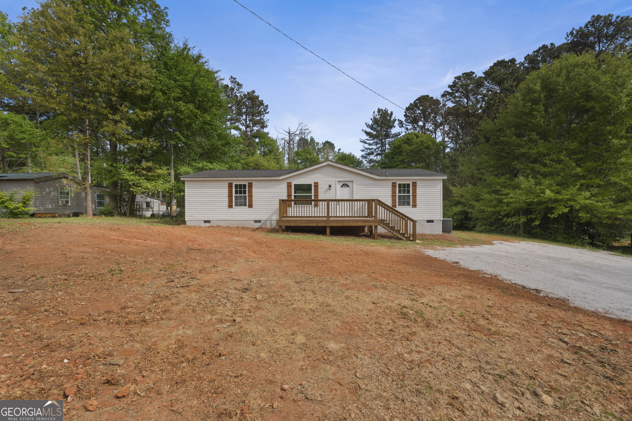110 Kathy Lane Temple, GA 30179 - Photo 3 of 24 a front view of a house with a garden and trees