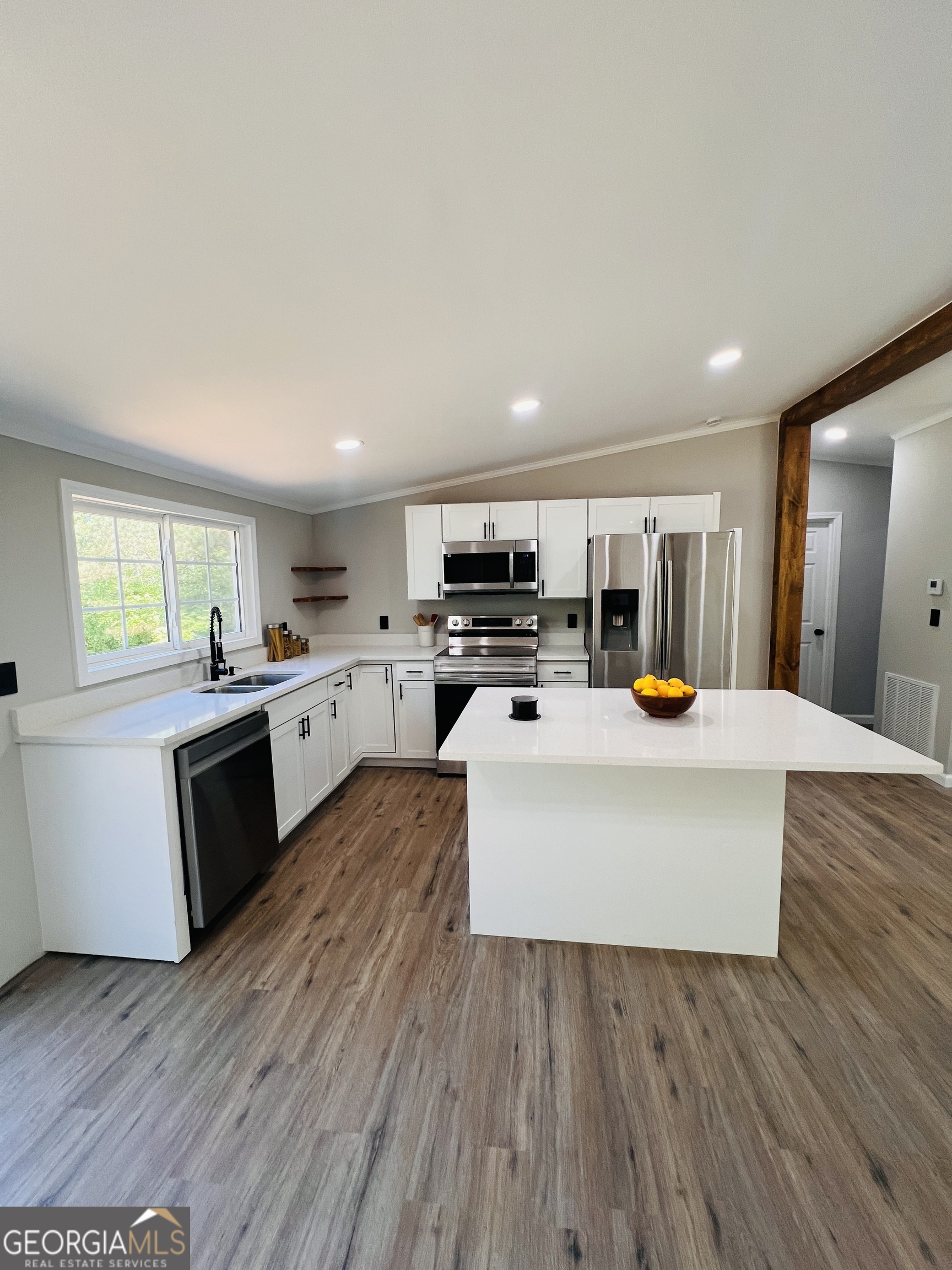 110 Kathy Lane Temple, GA 30179 - Photo 5 of 24 a large white kitchen with wooden floors and stainless steel appliances