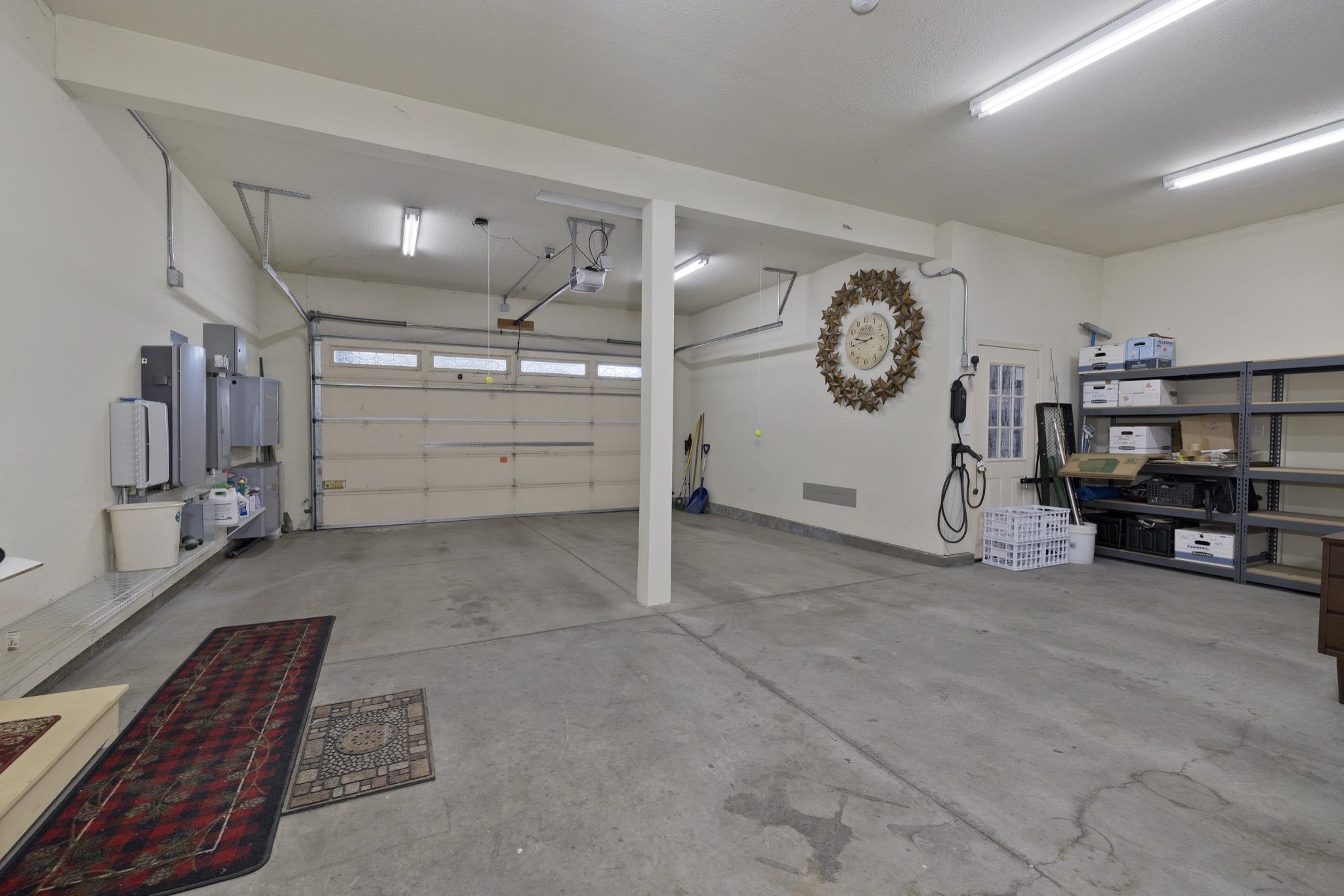 378 Ridge Way Mammoth Lakes, CA 93546 - Photo 36 of 43 Spacious garage featuring a concrete floor, two garage door openers, and fluorescent overhead lighting