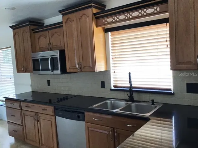a kitchen that has a sink and a stove
