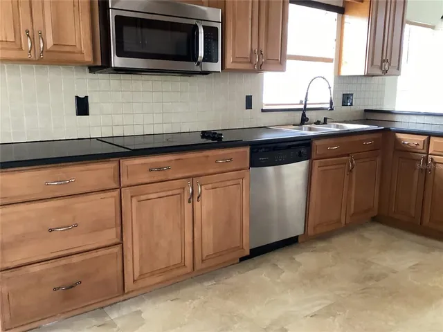 a view of a hallway with windows and cabinet