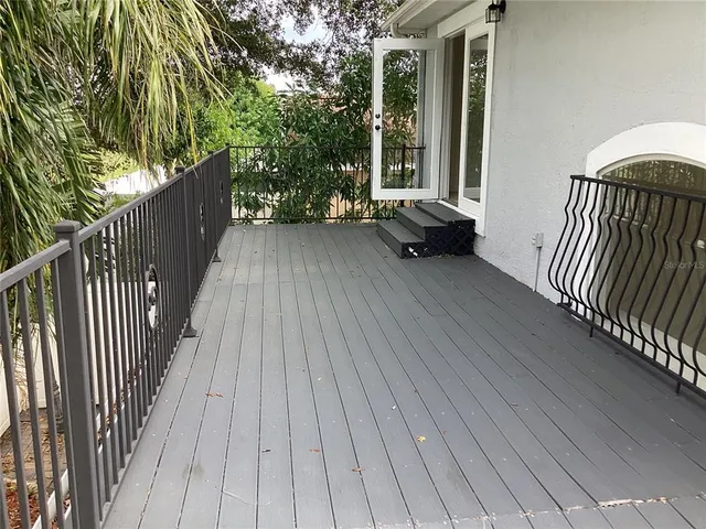 a view of backyard with deck and wooden floor