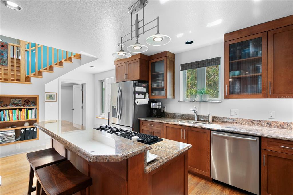2421 Brevard Road Northeast St. Petersburg, FL 33704 - Photo 13 of 35 a kitchen with a sink a counter space dining table and chairs