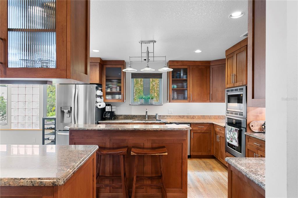 2421 Brevard Road Northeast St. Petersburg, FL 33704 - Photo 14 of 35 a kitchen with stainless steel appliances granite countertop a sink stove and refrigerator