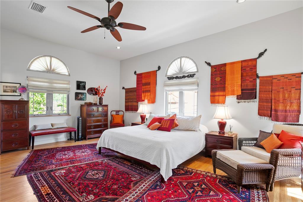 2421 Brevard Road Northeast St. Petersburg, FL 33704 - Photo 21 of 35 a bedroom with a bed and wooden floor