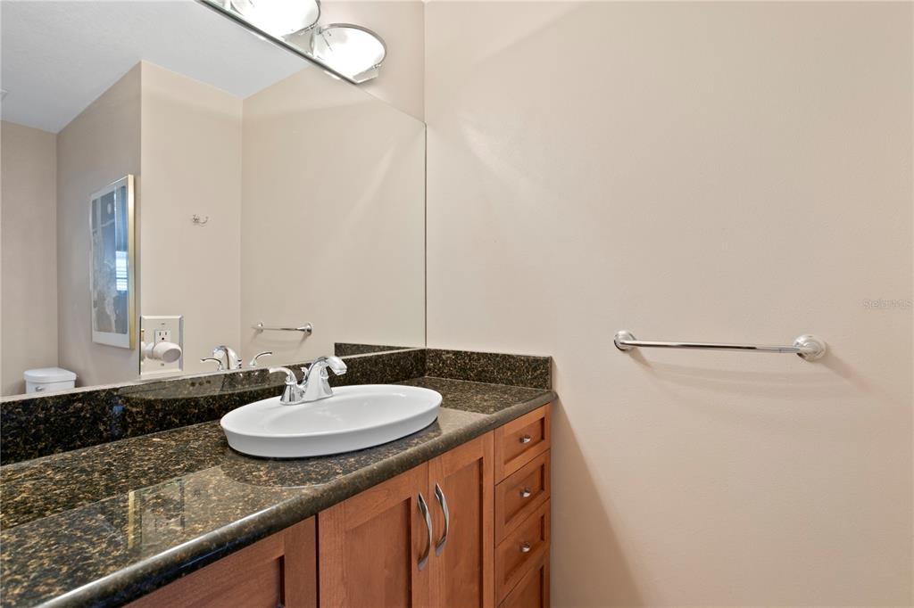 2421 Brevard Road Northeast St. Petersburg, FL 33704 - Photo 26 of 35 a bathroom with a sink and a mirror