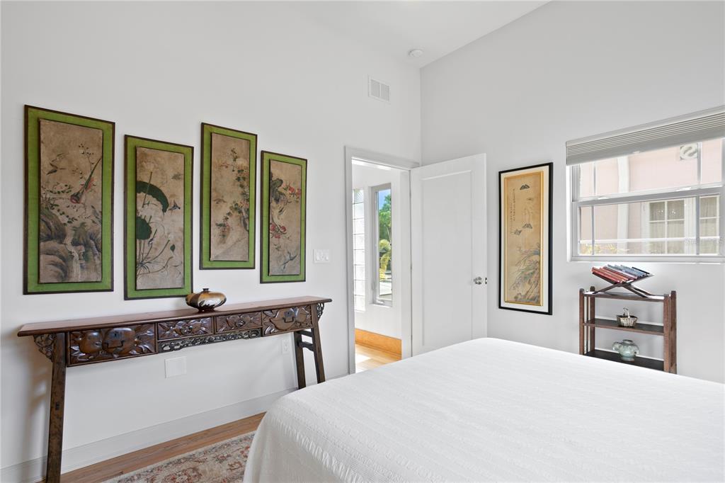 2421 Brevard Road Northeast St. Petersburg, FL 33704 - Photo 28 of 35 a bedroom with a bed and a large mirror next to a window