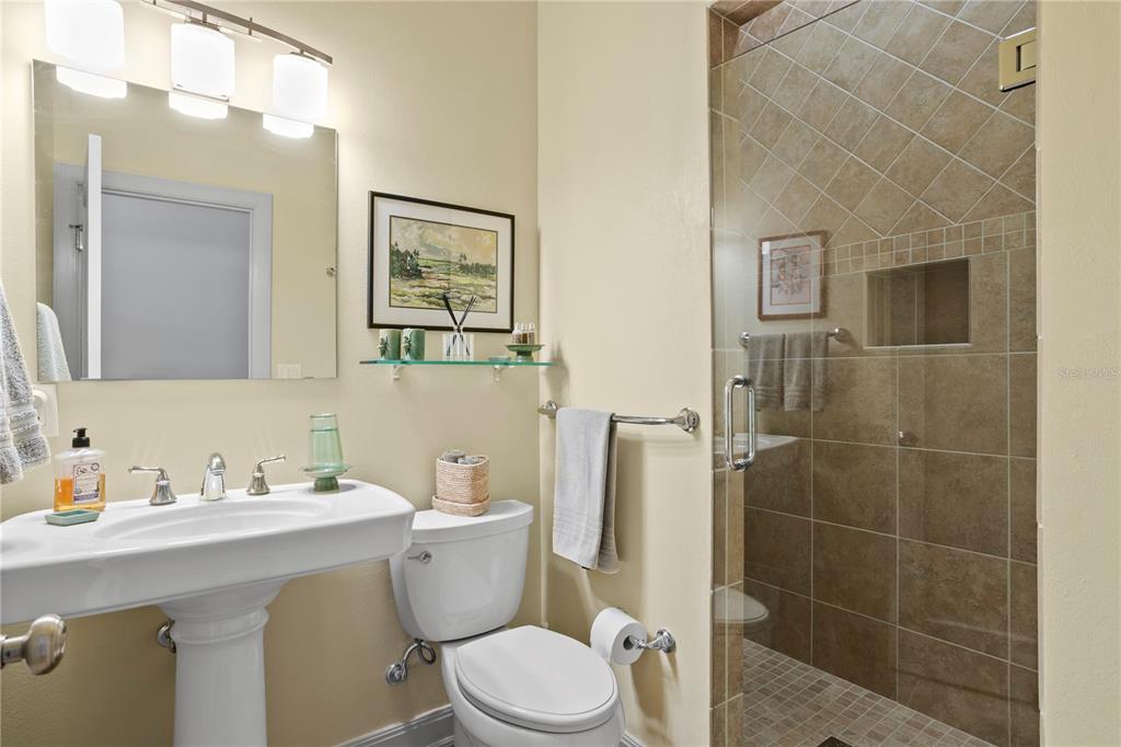 2421 Brevard Road Northeast St. Petersburg, FL 33704 - Photo 29 of 35 a bathroom with a toilet sink and mirror
