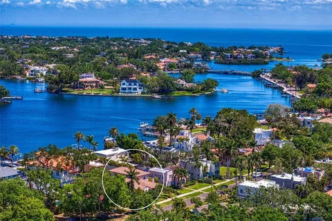 an aerial view of a houses with a lake view