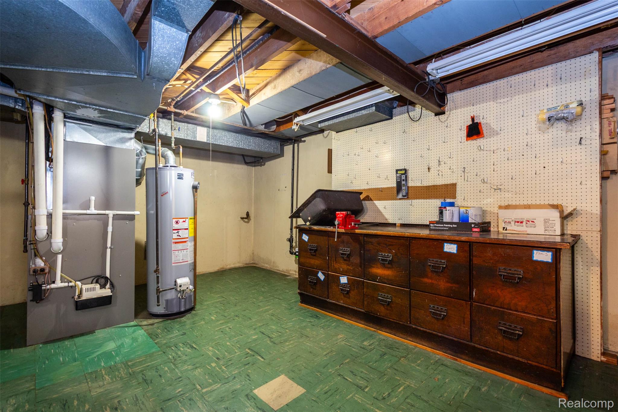 14869 Champaign Road Allen Park, MI 48101 - Photo 28 of 34 Utility area featuring exposed ceiling joists, a water heater, a furnace, and a pegboard-lined wall