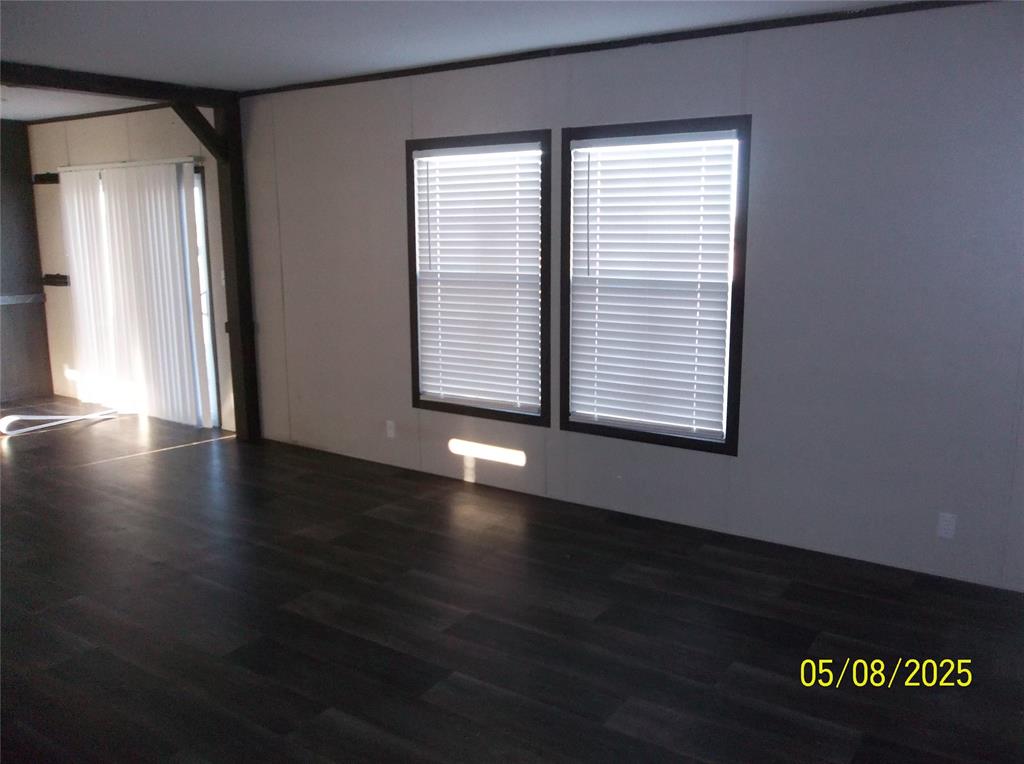531 Blair Road Waxahachie, TX 75165 - Photo 11 of 40 an empty room with wooden floor and windows