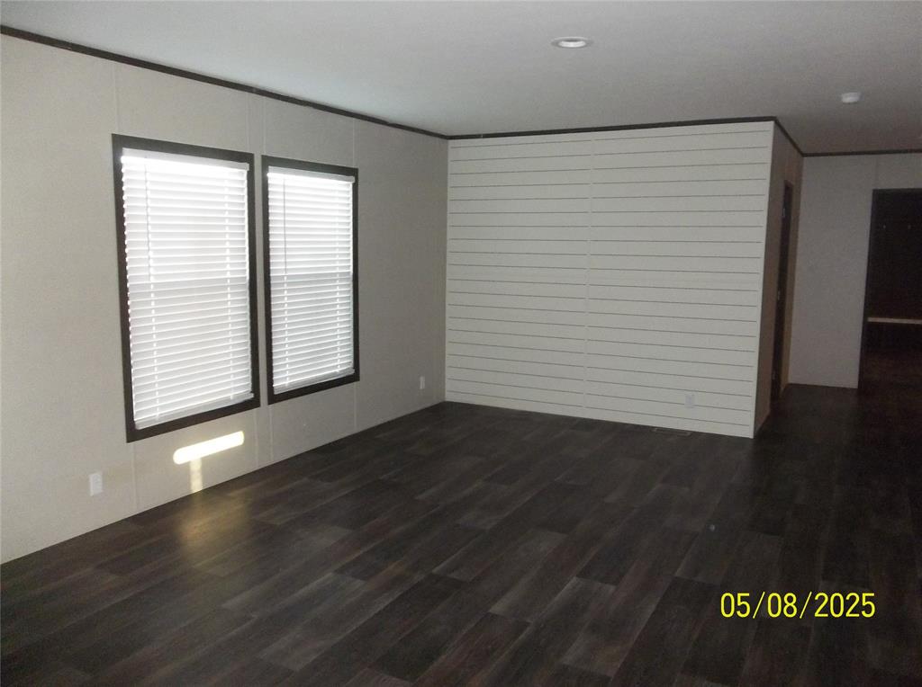 531 Blair Road Waxahachie, TX 75165 - Photo 14 of 40 an empty room with wooden floor and windows