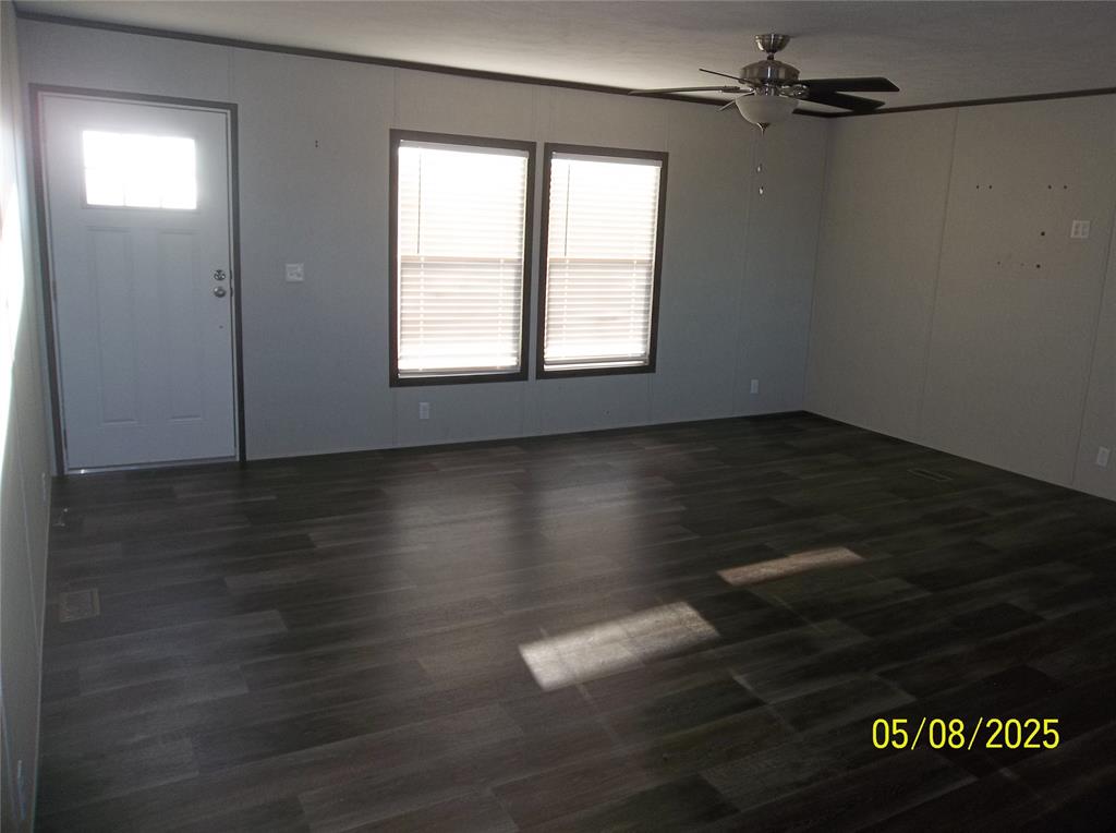 531 Blair Road Waxahachie, TX 75165 - Photo 16 of 40 an empty room with wooden floor cabinet and windows
