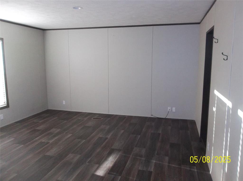 531 Blair Road Waxahachie, TX 75165 - Photo 21 of 40 a view of an empty room with wooden floor and a window