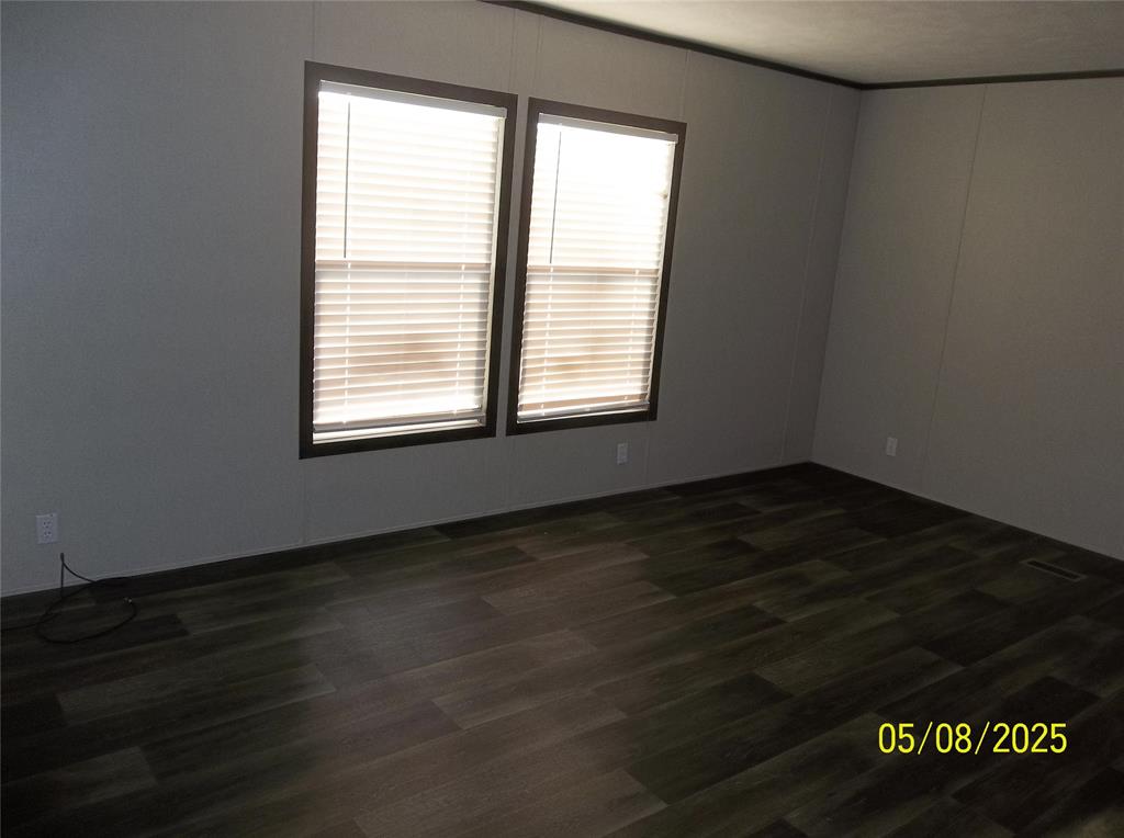 531 Blair Road Waxahachie, TX 75165 - Photo 22 of 40 a view of an empty room with wooden floor and a window