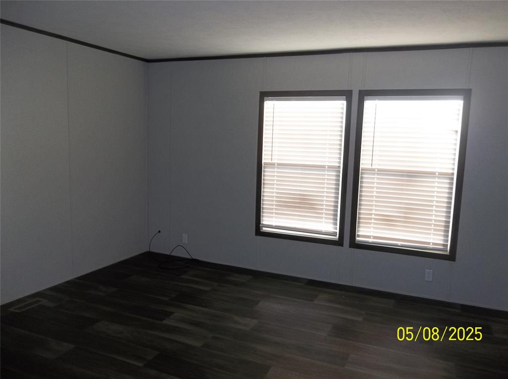531 Blair Road Waxahachie, TX 75165 - Photo 23 of 40 a view of an empty room with wooden floor and a window