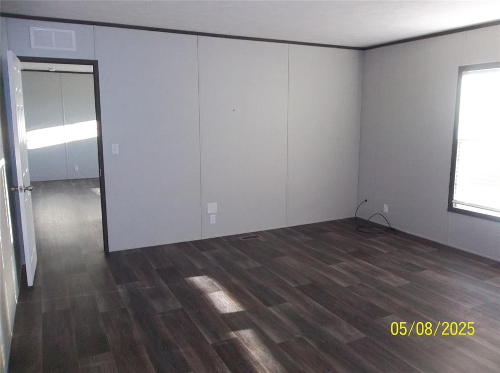 531 Blair Road Waxahachie, TX 75165 - Photo 24 of 40 a view of an empty room with wooden floor and a window