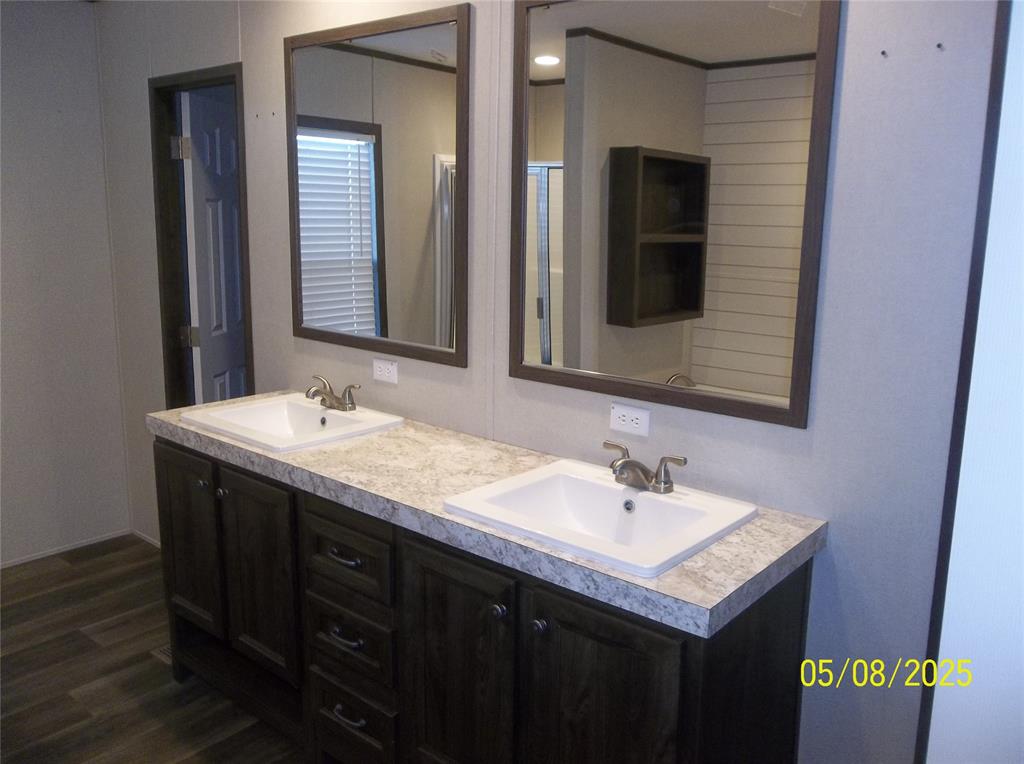 531 Blair Road Waxahachie, TX 75165 - Photo 27 of 40 a bathroom with a sink and a mirror
