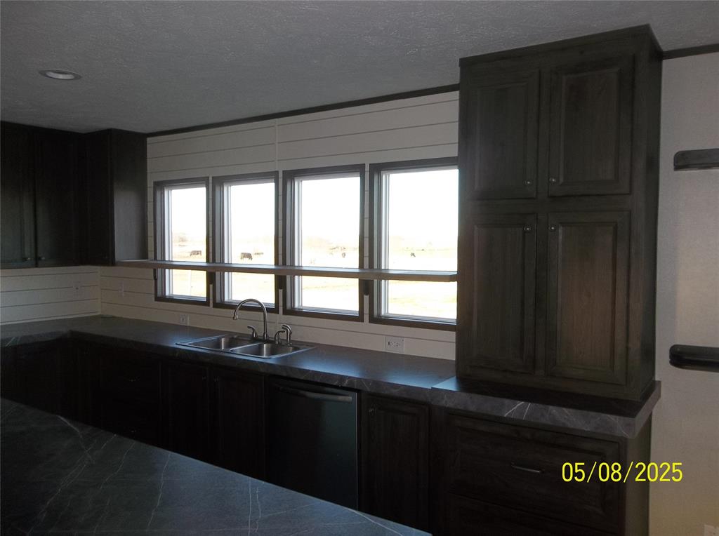 531 Blair Road Waxahachie, TX 75165 - Photo 28 of 40 a kitchen with a sink a window and cabinets