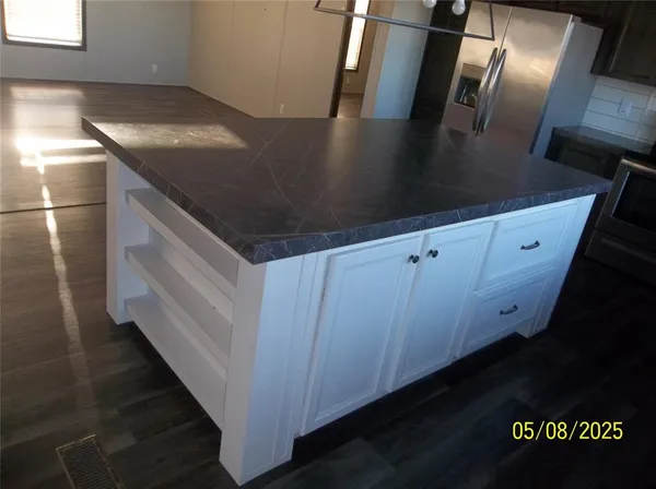 a view of a refrigerator a sink and dishwasher in a kitchen