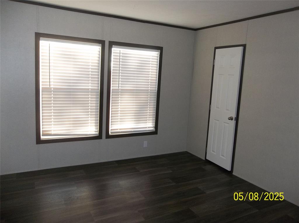 531 Blair Road Waxahachie, TX 75165 - Photo 9 of 40 a view of an empty room with wooden floor and a window