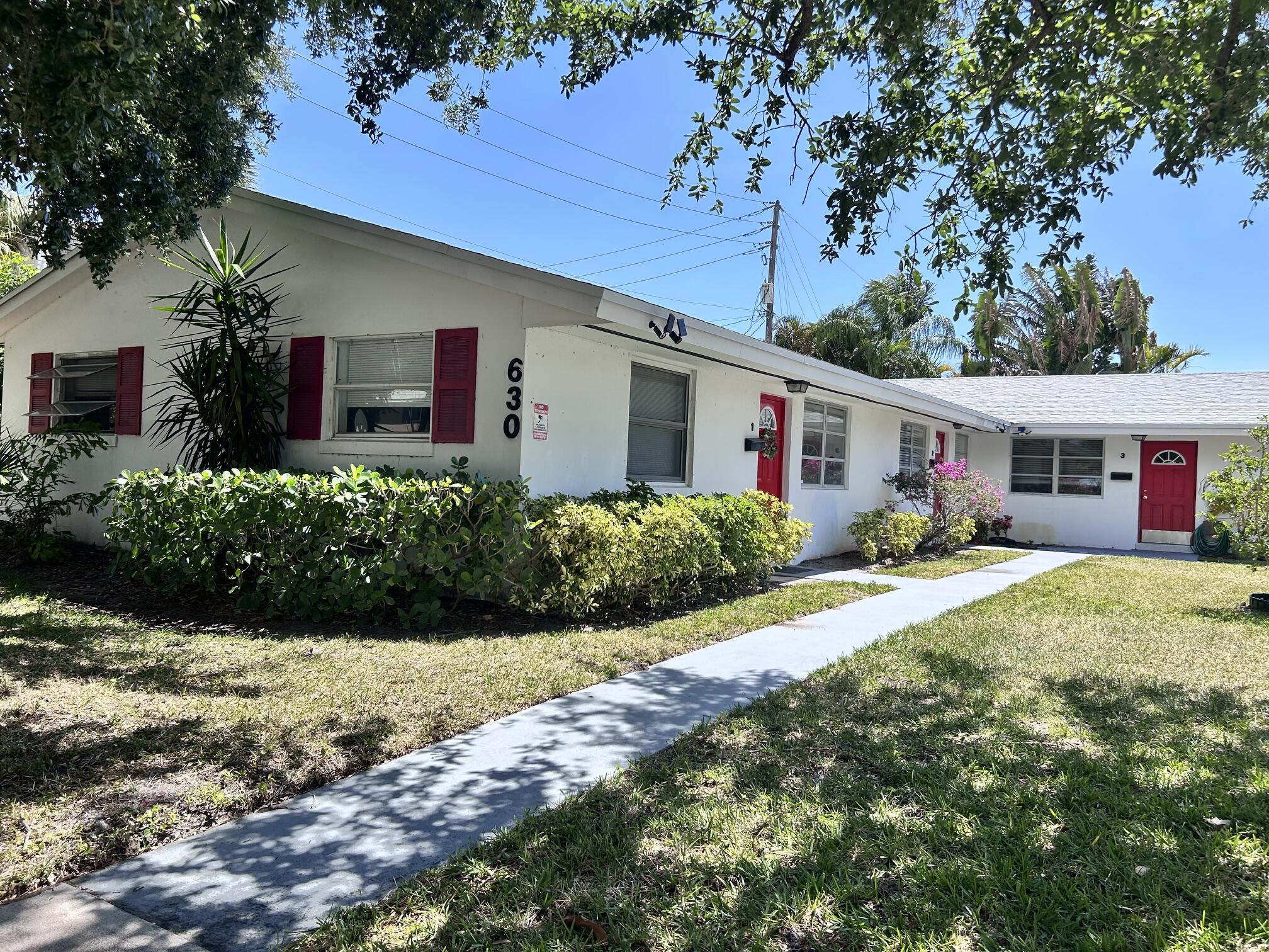 630 Prosperity Farms Road, Unit 2 North Palm Beach, FL 33408 - Photo 2 of 13 front view of a house with a patio