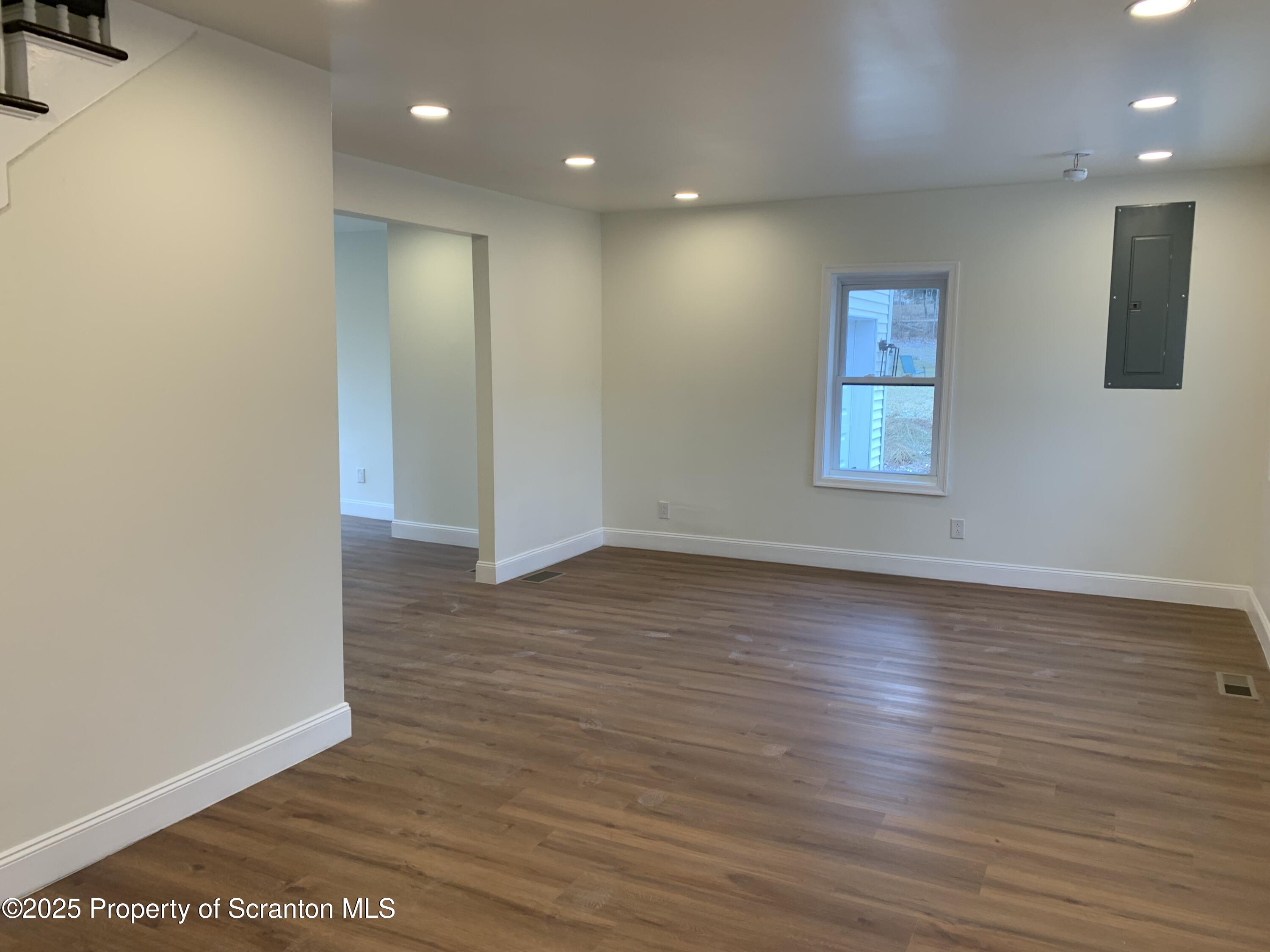 318 Simrell Road Clarks Summit, PA 18411 - Photo 12 of 30 an empty room with wooden floor and windows