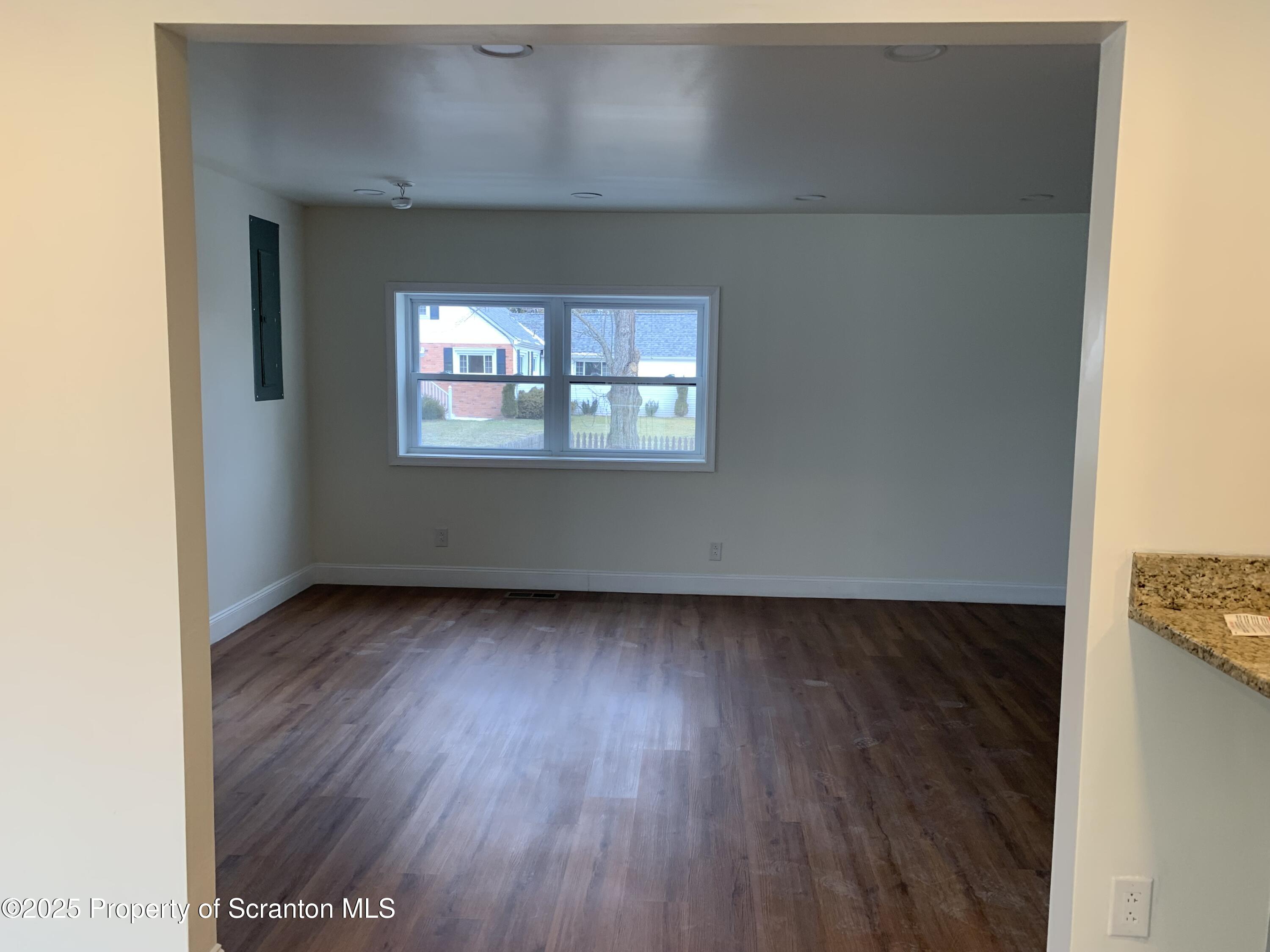 318 Simrell Road Clarks Summit, PA 18411 - Photo 13 of 30 an empty room with wooden floor and windows