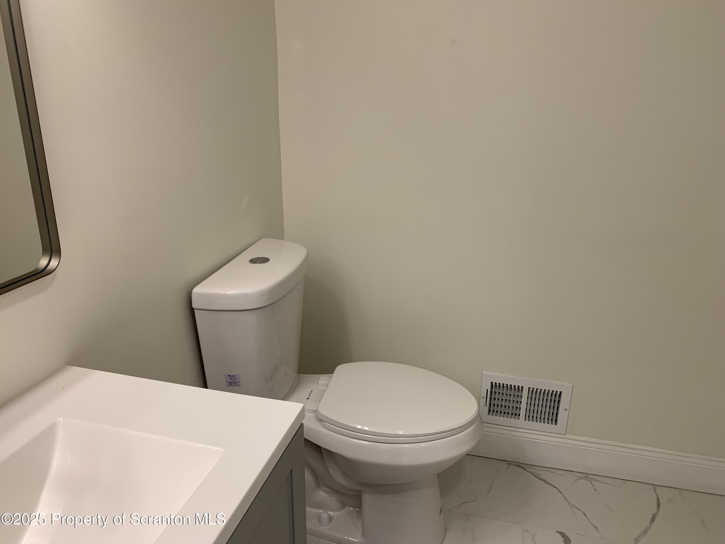 318 Simrell Road Clarks Summit, PA 18411 - Photo 20 of 30 a white toilet sitting next to a white sink