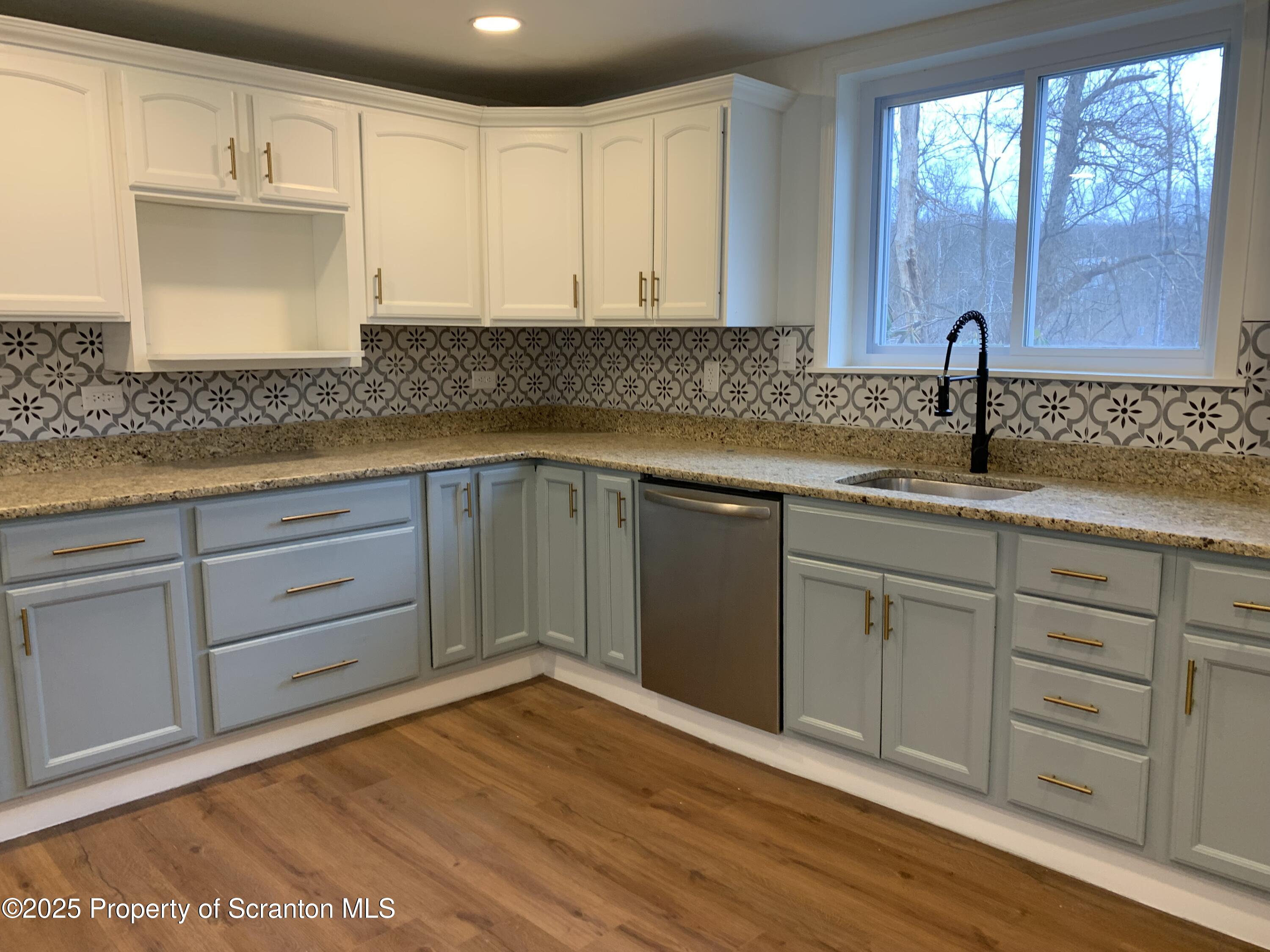 318 Simrell Road Clarks Summit, PA 18411 - Photo 2 of 30 a kitchen with white cabinets sink and window