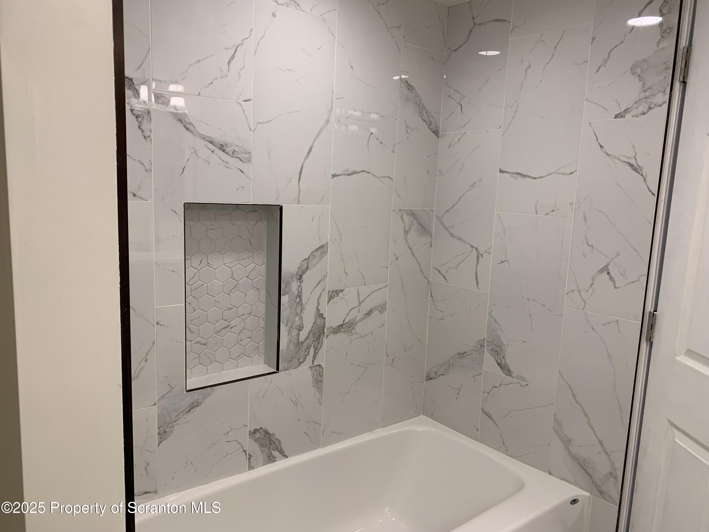 318 Simrell Road Clarks Summit, PA 18411 - Photo 21 of 30 a bathroom with a bathtub and shower