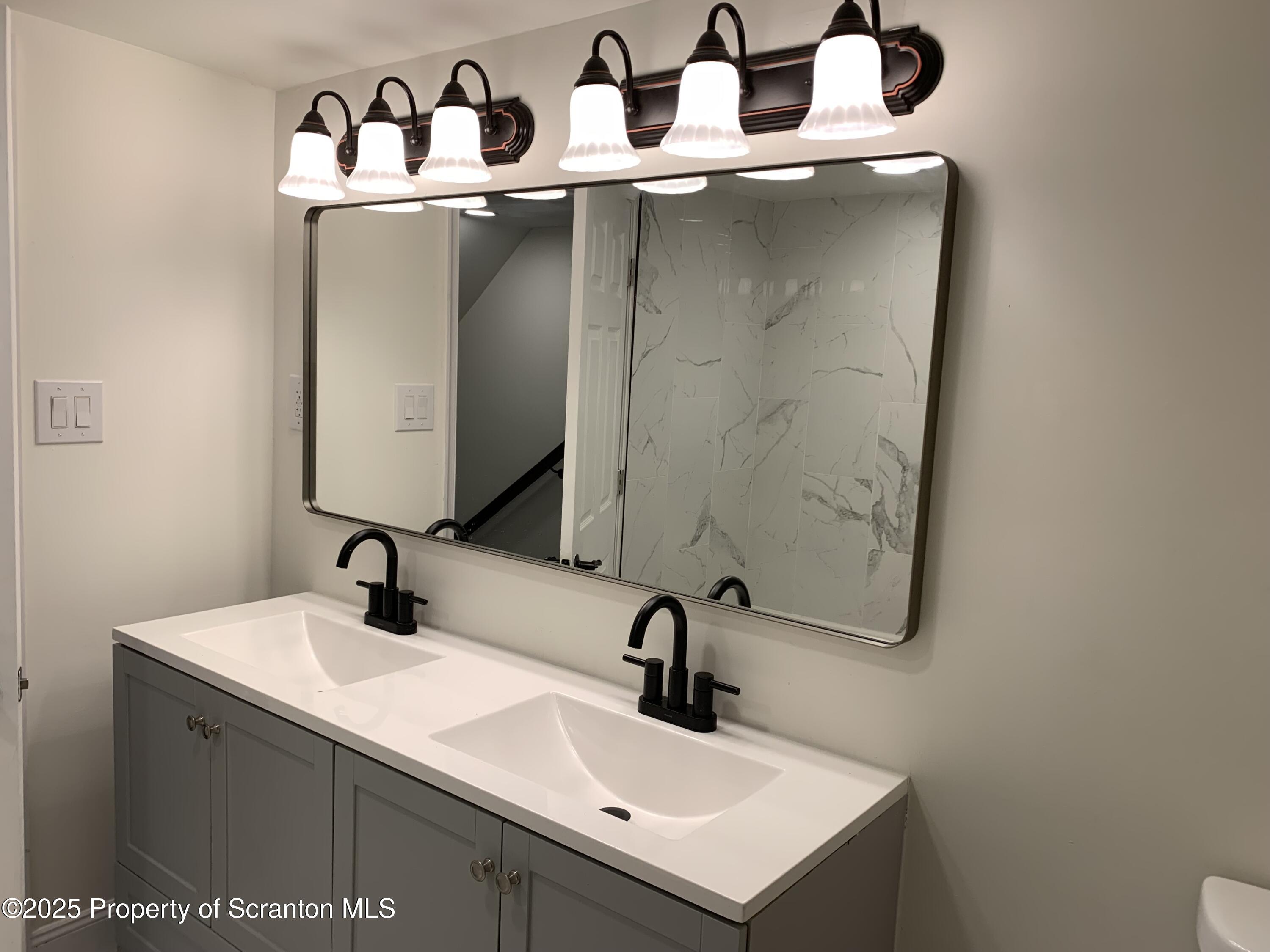 318 Simrell Road Clarks Summit, PA 18411 - Photo 22 of 30 a bathroom with a sink and a mirror
